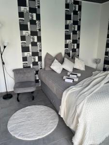 a living room with a bed and a chair at Magnifique studio in Bressols