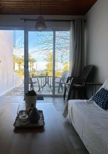 a bedroom with a bed and a view of the ocean at Seafront Escape in Latchi in Polis Chrysochous