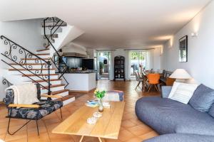 a living room with a couch and a table at VILLA LUNA VI4339 By Riviera Holiday Homes in Èze