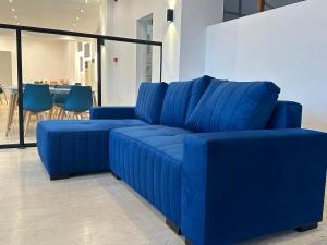 ein blaues Sofa in einem Zimmer mit einem Tisch in der Unterkunft Olympian Altis Hotel in Olympia