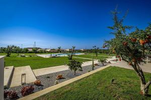 a park with an orange tree and a skate park at Shalamu Luxury Apartments in Rosolini