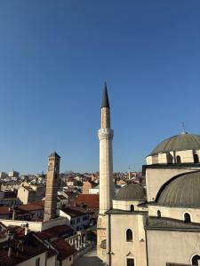 a mosque with a minaret in the middle of a city at Luxury Studio Black & White in Sarajevo