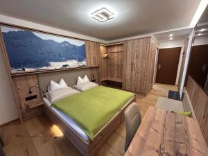 a bedroom with a bed and a large window at Smarthotel inAlpe in Obertauern