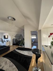 a living room with a large black rug on the floor at Luxury Studio Black & White in Sarajevo