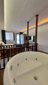 a large white bath tub in a room at The Kumsal Hotel Oludeniz in Oludeniz