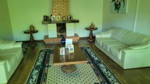 a living room with two couches and a coffee table at Pousada Serrana in Coimbra
