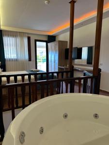 a white tub in a room with a dining room at The Kumsal Hotel Oludeniz in Oludeniz +37 photos