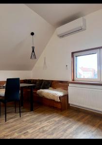 a room with a bed and a table and a window at Penzion Slovácko 2 in Ostrožská Nová Ves