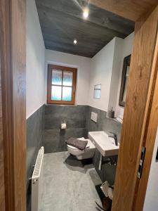 a bathroom with a toilet and a sink at Ferienwohnung Wiagsog in Garmisch-Partenkirchen +11 photos