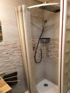 a shower with a shower curtain in a bathroom at 10 min de Cortè, 5 couchages, in Venaco +28 photos