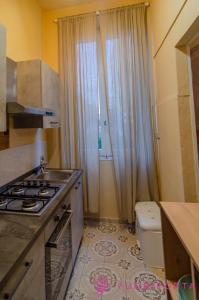 a small kitchen with a sink and a toilet at La Magnolia del Ducato in Parma