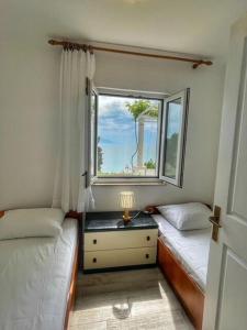 Posteľ alebo postele v izbe v ubytovaní Apartments Sea View