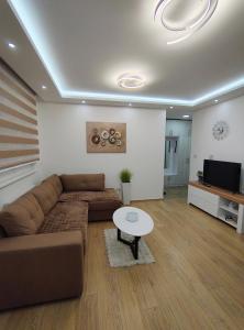 a living room with a couch and a table at Apartman Vanesa in Banja Koviljača