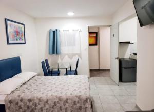 a bedroom with a bed and a table and chairs at Casa Aura in Isla Mujeres
