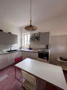 a kitchen with a large white table in a room at Villa Magnolia in Santo Spirito