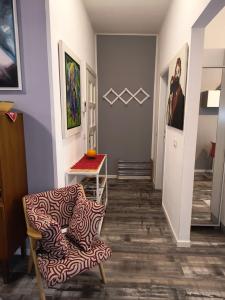a living room with a chair and a table at AppartamentoMonika con parcheggio privato - Volano in Volano +38 photos