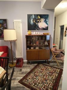 a living room with a tv on the wall at AppartamentoMonika con parcheggio privato - Volano in Volano