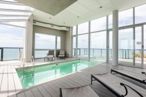 a large swimming pool in a building with windows at Residencias Roque Suarez in Mar del Plata
