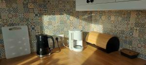 a kitchen counter with a coffee maker on a table at Pienińskie Kąty in Krościenko