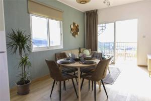 a dining room with a table and chairs at Green Oasis Penthouse in Peyia