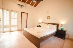 Кровать или кровати в номере VILLA M - SOLITUDE 1 CANDOLIM GOA 3BHK, Pool Facing, Near Beach, Free Breakfast, Free WIFI and Prime Location