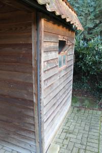 a wooden out house with a window in it at Ferienwohnung Walgernheide in Warendorf