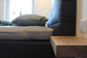 a pillow sitting on a bed next to a chair at Ferienwohnung Walgernheide in Warendorf
