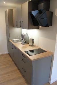 a kitchen with a sink and a counter top at Ferienwohnung Walgernheide in Warendorf
