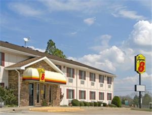 a mcdonalds restaurant with a sign in front of a building at Super 8 by Wyndham Batesville in Batesville