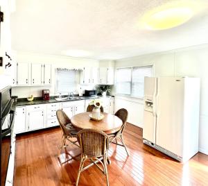 a kitchen with a table and chairs and a refrigerator at Campus Cottage in Marion
