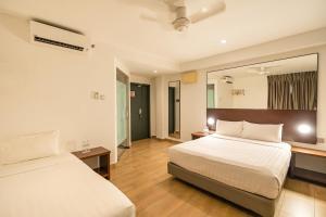 Postel nebo postele na pokoji v ubytování Tune Hotel Georgetown Penang