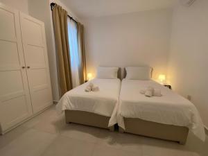 a bedroom with two beds with towels on them at Swieqi Malaika New Apt 1 with COURTYARD in Is-Swieqi