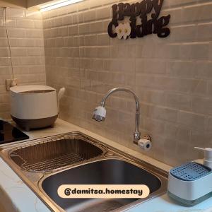 a kitchen counter with a sink and a mixer at Damitsa Homestay Syariah in Wonosobo +10 photos