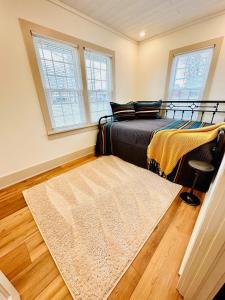 a bedroom with a bed and a rug at Tippecanoe Lakefront Classic Cottage in North Webster