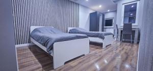 a hospital room with two beds and a television at Sachsenheim Rooms & Apartments in Sachsenheim