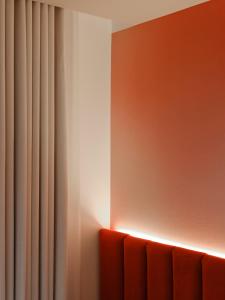 a room with a red couch and a curtain at Rose Hôtel Invisible in Quebec City +49 photos