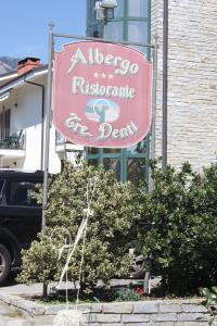 a pink sign for a restaurant on a building at Hotel Tre Denti in Cantalupa