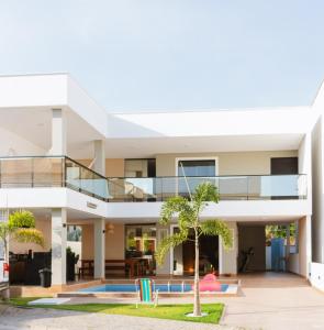 an exterior view of a house with a swimming pool at Casa Fênix - Casa de Temporada nos Lençóis Maranhenses in Barreirinhas
