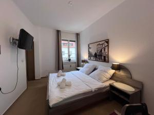 a bedroom with a bed with two towels on it at Hotel Doko Gardelegen in Gardelegen