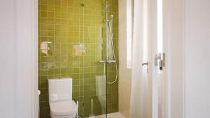 a bathroom with a shower with a toilet and a shower curtain at Maçãs Home-Land Sea View at The Beach in Colares +45 photos