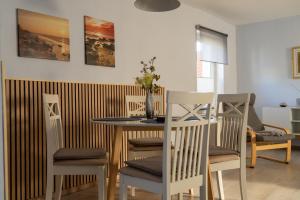 a dining room with a table and chairs at Kreide & Meer in Sassnitz