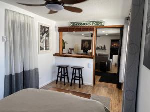a bedroom with a bed and a bar with stools at Our Place Up North BnB in Huntsville