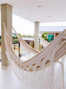 a hammock in a room with a building at Casa Fênix - Casa de Temporada nos Lençóis Maranhenses in Barreirinhas +61 photos