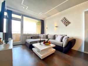 a living room with a couch and a coffee table at RelaxApartments ABENDSONNE im Herzen des Harzes - ein El Dorado für Wanderer, Biker und Ruhesuchende - mit sonnigem Balkon und Platz für bis zu 3 Personen in Hahnenklee-Bockswiese