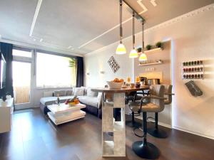 a living room with a couch and a table at RelaxApartments ABENDSONNE im Herzen des Harzes - ein El Dorado für Wanderer, Biker und Ruhesuchende - mit sonnigem Balkon und Platz für bis zu 3 Personen in Hahnenklee-Bockswiese +25 photos