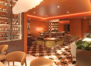 a restaurant with tables and chairs and a bar at Kimpton Atlantico Algarve by IHG in Albufeira