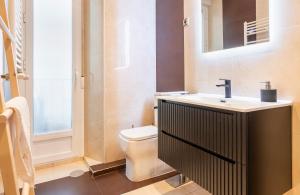 een badkamer met een wastafel en een toilet bij Exclusivo apartamento en el centro by beBalmy in Madrid