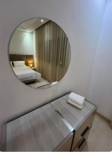 a mirror in a room with a bed and a table at Charmant appartement à Tunis ! in Tunis