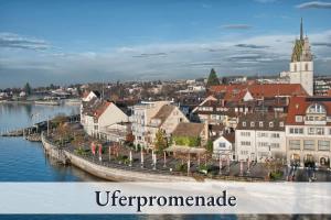a town next to a body of water with a city at Ferienwohnung EDEN Apartment´s Vinum in Friedrichshafen