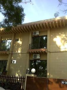 a house with a fence in front of it at Savoy Inn Guest House Islamabad in Islamabad